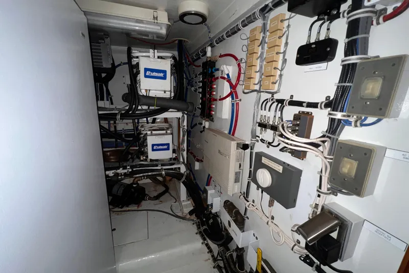 Slide: The Image of Engine room of 2001 Hatteras 65 Convertible with electrical systems and components. - 56