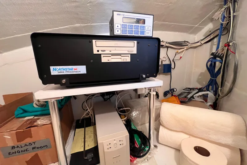 Slide: The Image of Northstar 962 Processor in 2001 Hatteras 65 Convertible engine room, with cables and equipment. - 60
