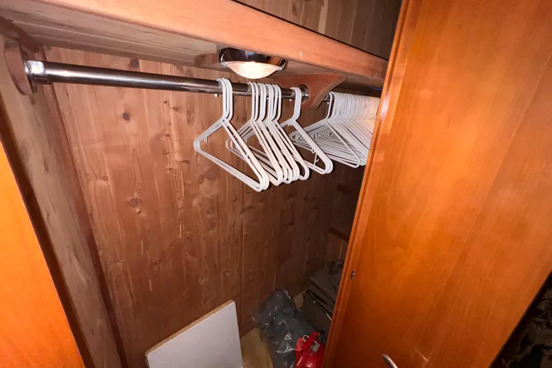 Slide: The Image of Wooden closet interior with hangers on a Hatteras 65 Convertible yacht, 2001 model. - 62