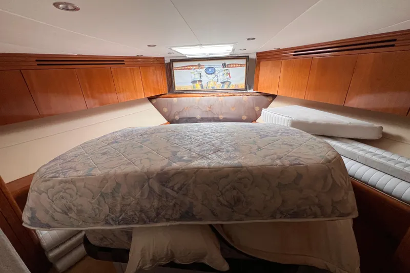 Slide: The Image of Luxurious cabin interior of 2001 Hatteras 65 Convertible yacht with wooden cabinetry. - 64