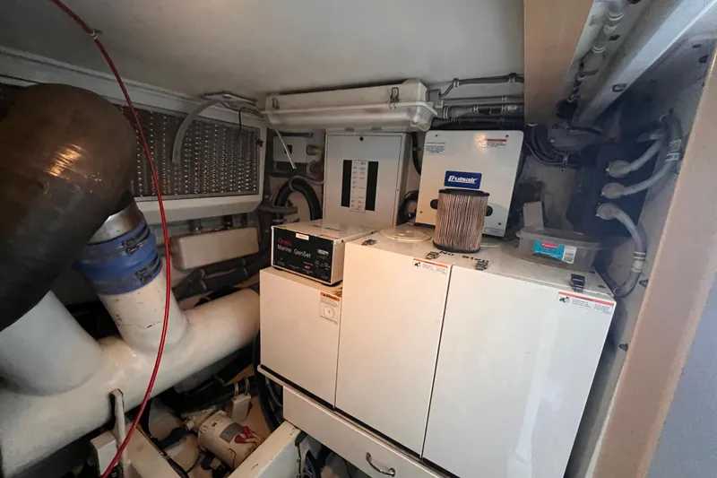 Slide: The Image of Engine room of 2001 Hatteras 65 Convertible yacht with marine equipment and systems. - 76