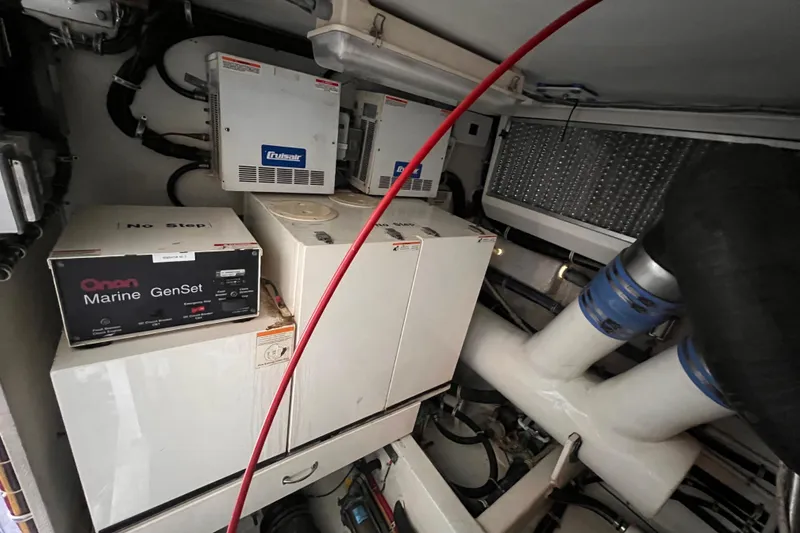 Slide: The Image of Engine room of 2001 Hatteras 65 Convertible with Onan Marine GenSet and Cruisair systems. - 77