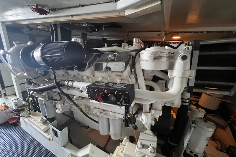 Slide: The Image of Engine room of 2001 Hatteras 65 Convertible yacht, showcasing detailed machinery and components. - 82