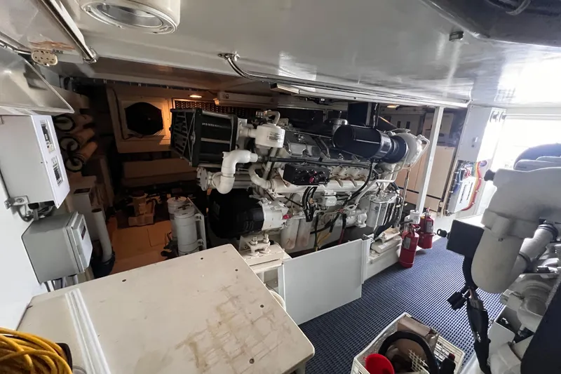 Slide: The Image of Engine room of 2001 Hatteras 65 Convertible yacht, showcasing machinery and equipment. - 85