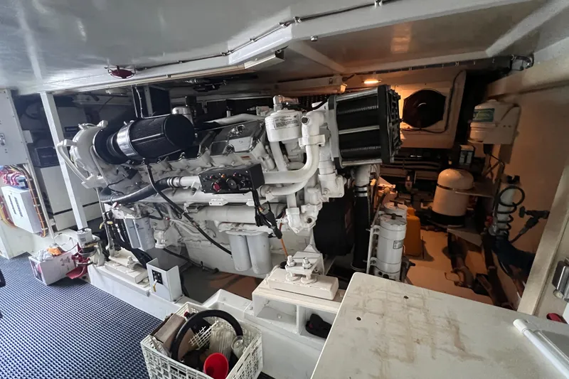Slide: The Image of Engine room of a 2001 Hatteras 65 Convertible yacht, showcasing detailed machinery. - 89