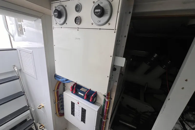 Slide: The Image of Engine room of 2001 Hatteras 65 Convertible yacht with control panel and wiring. - 93
