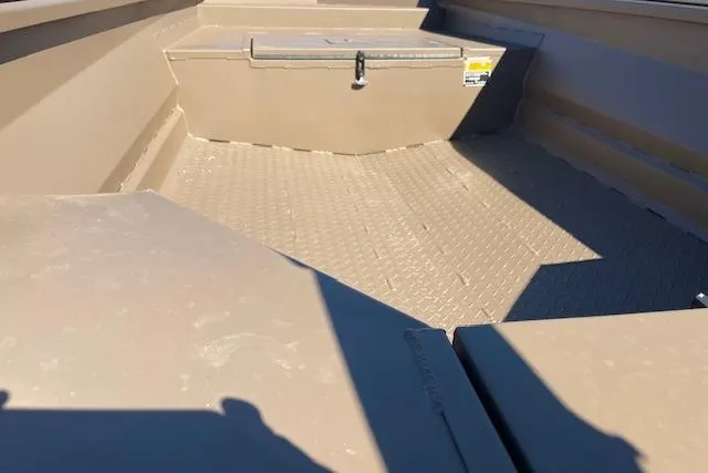 Slide: The Image of 2026 Reaper Boats 550-1880 interior with storage compartment and textured flooring. - 2