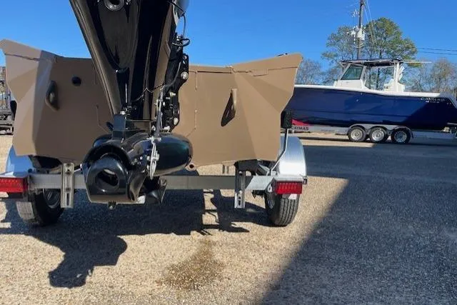 Slide: The Image of Reaper Boats 550-1880, 2026 model, on trailer with another boat in the background. - 5