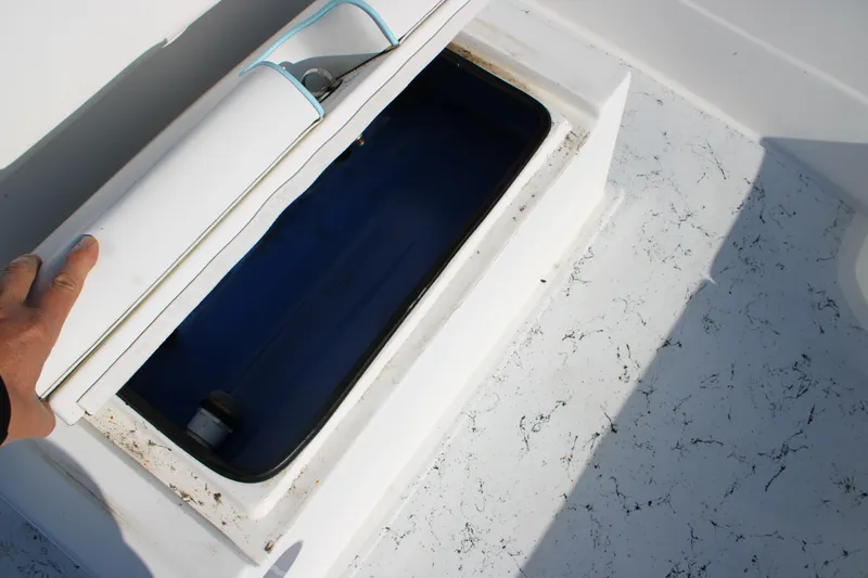Slide: The Image of 2008 Shallow Sport 24 Modified V boat storage compartment with blue interior. - 11