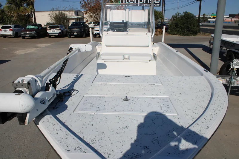 Slide: The Image of 2008 Shallow Sport 24 Modified V boat with trolling motor, parked outdoors. - 6