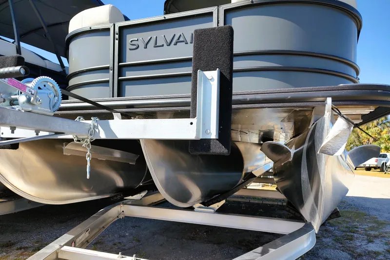Slide: The Image of 2026 Sylvan Mirage X3 CLZ DH pontoon boat on trailer, close-up view. - 10