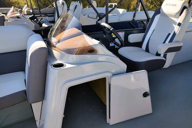Slide: The Image of 2026 Sylvan Mirage X3 CLZ DH boat interior with steering console and seating. - 12