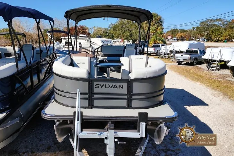 Slide: The Image of 2026 Sylvan Mirage X3 CLZ DH pontoon boat displayed at a marina. - 3