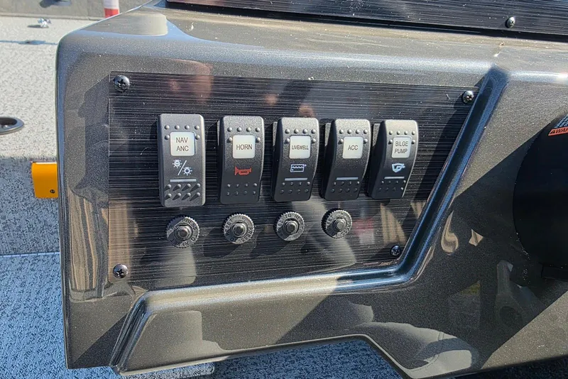 Slide: The Image of Control panel of 2026 Smoker Craft Viper 165 boat with labeled switches. - 14