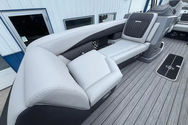 Slide: The Image of 2026 Harris Sunliner 230 boat interior with luxurious gray seating and modern design. - 10