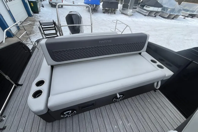 Slide: The Image of 2026 Harris Sunliner 230 boat interior with cushioned seating and cup holders. - 13