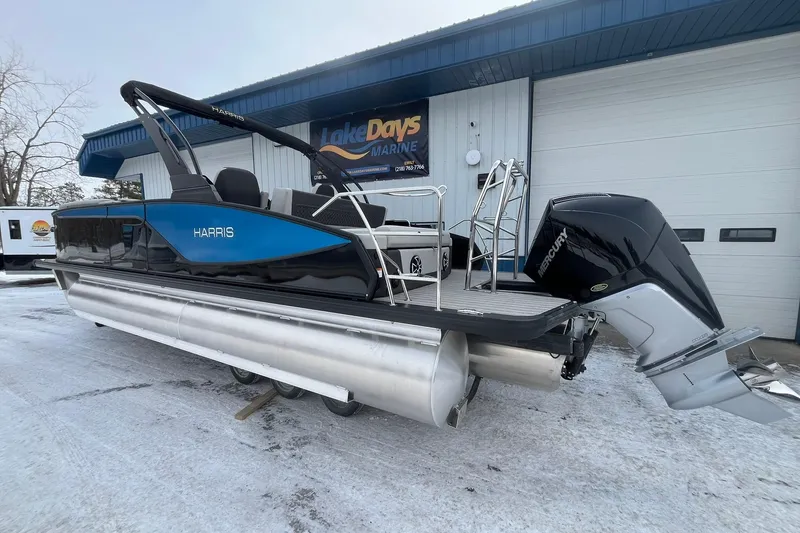 Slide: The Image of 2026 Harris Sunliner 230 pontoon boat with Mercury outboard motor, displayed at Lake Days Marine. - 2