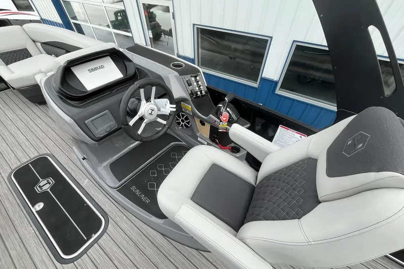 Slide: The Image of 2026 Harris Sunliner 230 boat interior with modern helm and comfortable seating. - 22