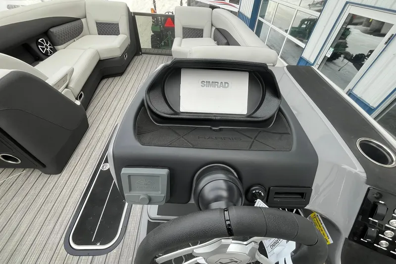 Slide: The Image of Interior of 2026 Harris Sunliner 230 boat with Simrad navigation system and luxurious seating. - 24