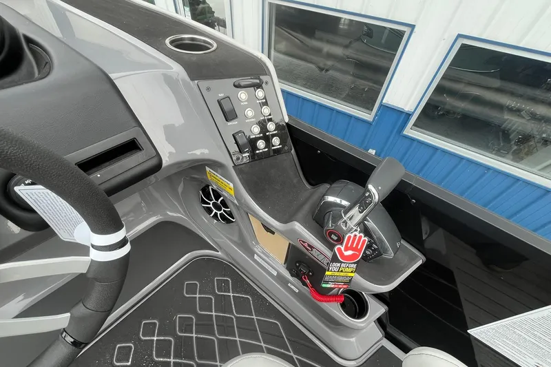 Slide: The Image of 2026 Harris Sunliner 230 boat console with controls and steering wheel. - 25