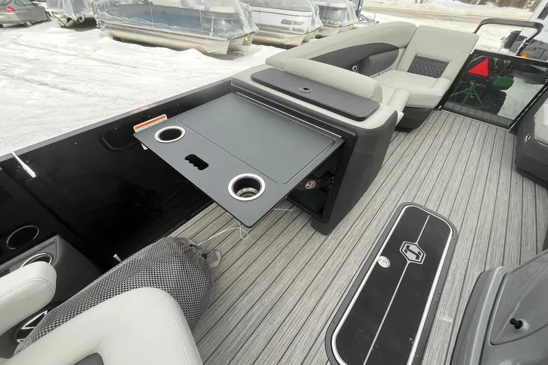 Slide: The Image of 2026 Harris Sunliner 230 interior with foldable table and seating on a snowy day. - 27