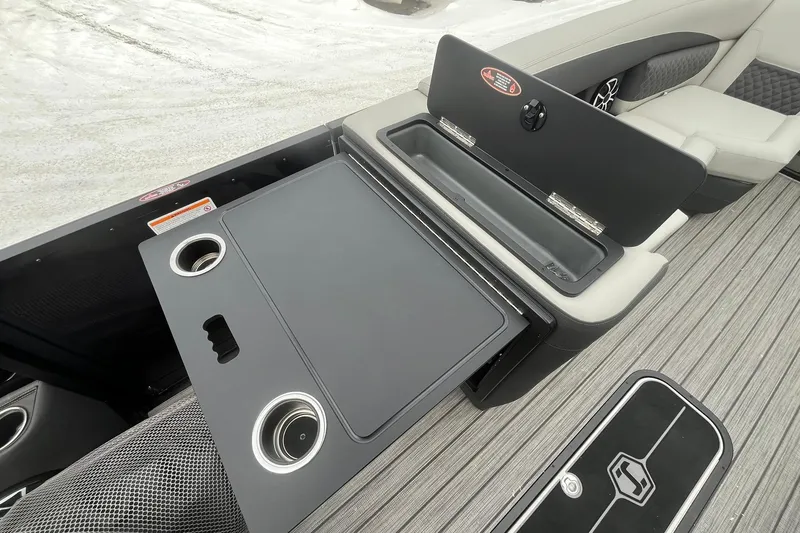 Slide: The Image of 2026 Harris Sunliner 230 interior with cup holders and storage compartment. - 28