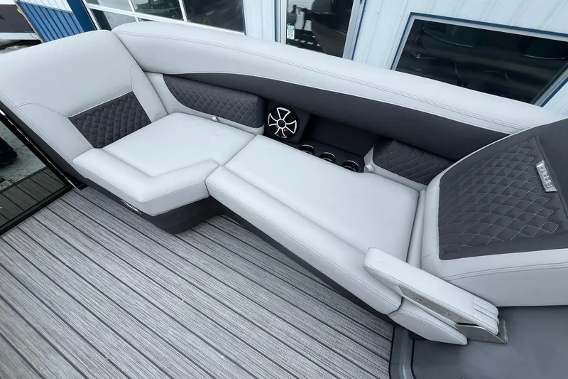 Slide: The Image of Luxurious seating on 2026 Harris Sunliner 230 boat with quilted upholstery and cup holders. - 30