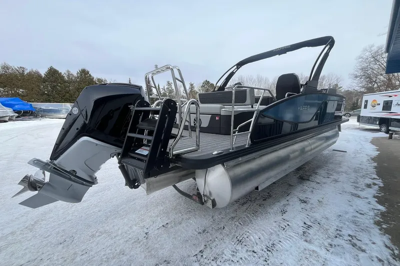 Slide: The Image of 2026 Harris Sunliner 230 pontoon boat with outboard motor on snowy ground. - 4