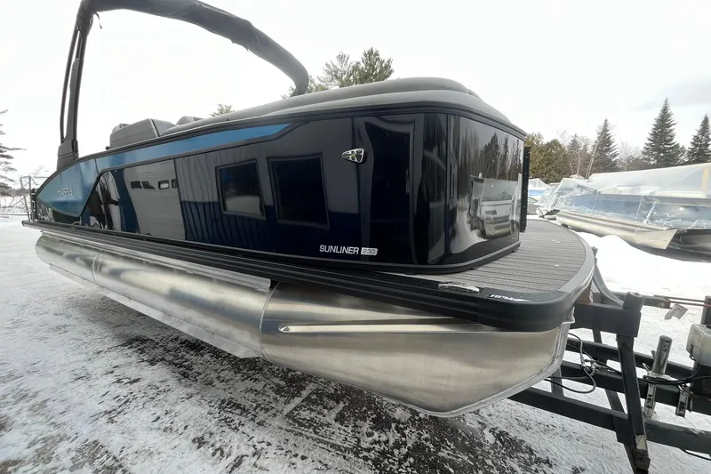 Slide: The Image of 2026 Harris Sunliner 230 pontoon boat on snowy ground, showcasing sleek design and modern features. - 5