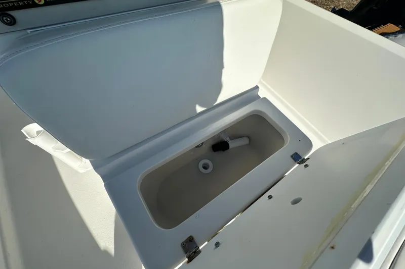 Slide: The Image of Open storage compartment on 2001 Aquasport 200 Osprey boat, showing interior details. - 10