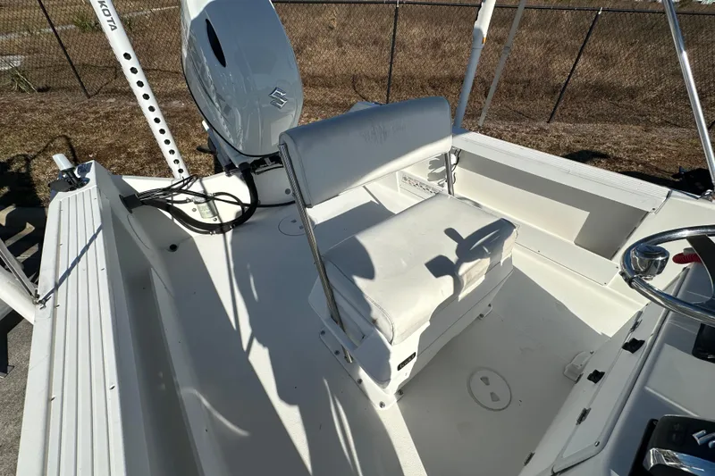 Slide: The Image of 2001 Aquasport 200 Osprey boat interior with white seating and steering console. - 11