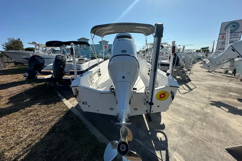 Slide: The Image of 2001 Aquasport 200 Osprey boat with outboard motor in a sunny marina. - 4