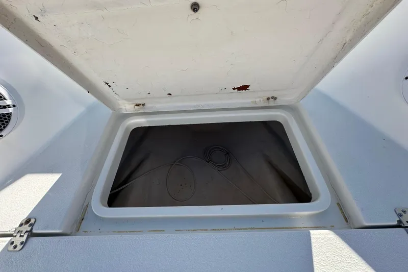 Slide: The Image of Open storage compartment on 2001 Aquasport 200 Osprey boat, showing interior details. - 7