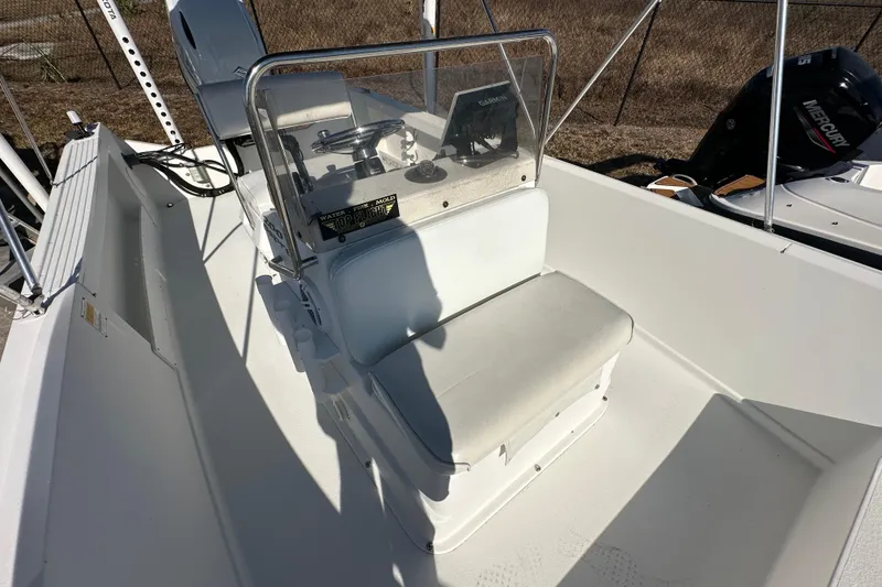 Slide: The Image of 2001 Aquasport 200 Osprey boat interior with steering console and seating. - 9