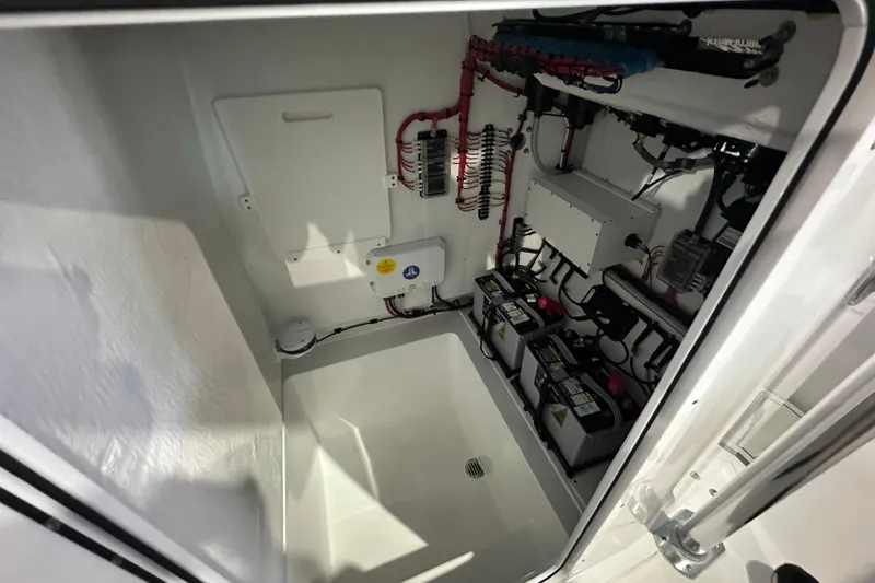 Slide: The Image of Electrical compartment of 2026 Bluewater 23T boat with batteries and wiring. - 12