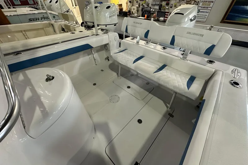 Slide: The Image of 2026 Bluewater 23T boat interior with white and blue seating, showcasing modern design. - 14