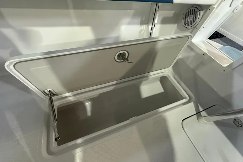 Slide: The Image of Open storage compartment in 2026 Bluewater 23T boat interior. - 16