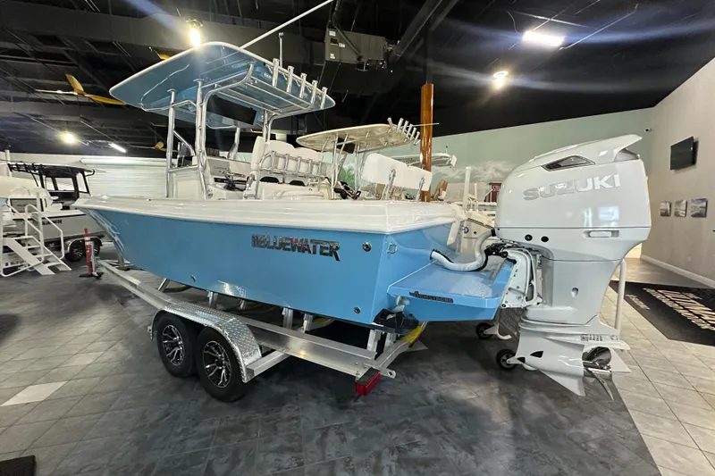 Slide: The Image of 2026 Bluewater 23T boat with Suzuki engine on display in showroom. - 3