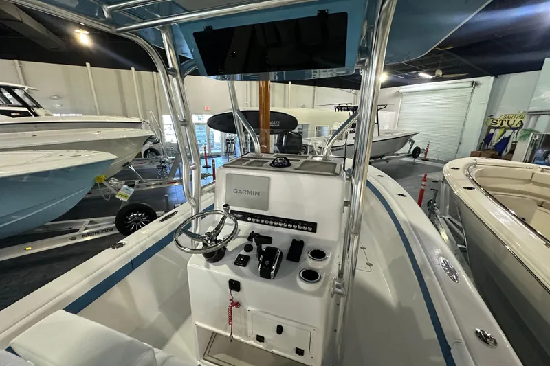 Slide: The Image of 2026 Bluewater 23T boat interior with Garmin navigation system in showroom. - 5