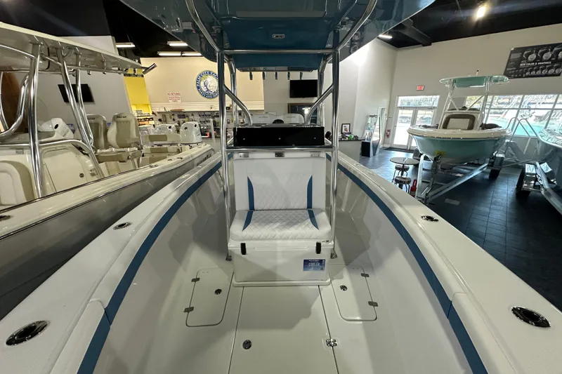 Slide: The Image of 2026 Bluewater 23T boat interior, showroom display with seating and console. - 8