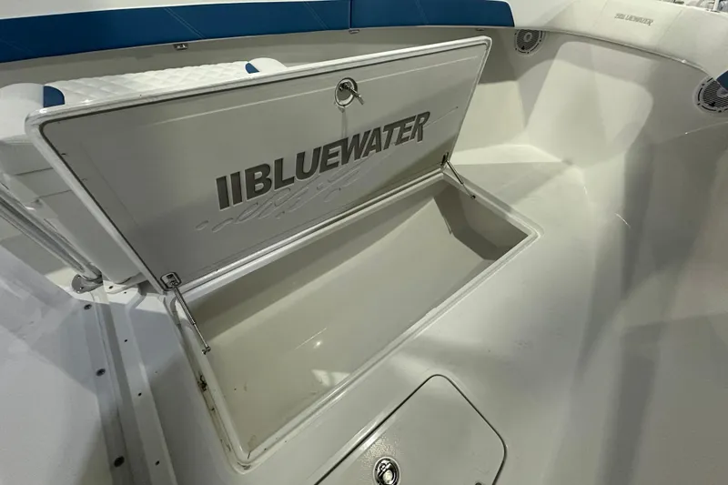 Slide: The Image of 2026 Bluewater 23T boat storage compartment open, showcasing interior space. - 9