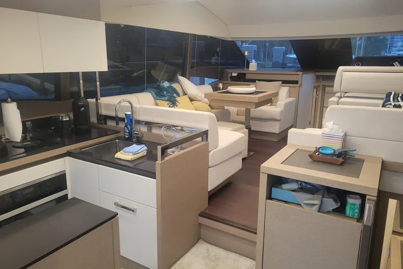 Slide: The Image of Prestige 520 yacht, 2018 model, docked near palm trees and waterfront homes. - 10