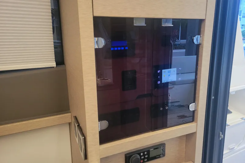 Slide: The Image of 2018 Prestige 520 yacht interior with open storage compartment and wooden steps. - 17