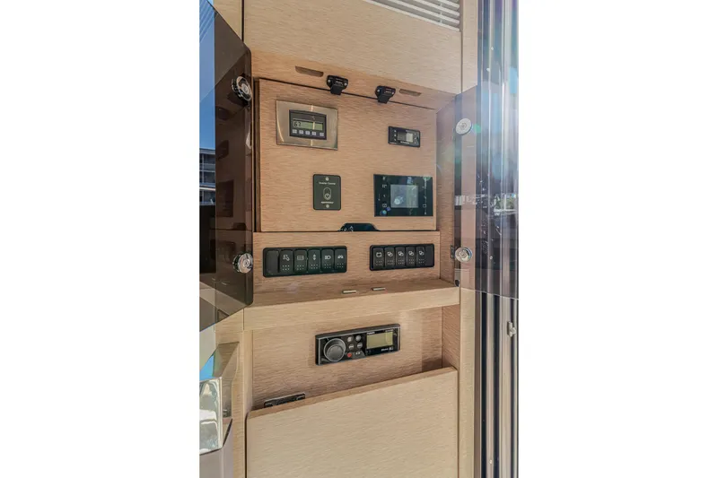 Slide: The Image of Control panel of a 2018 Prestige 520 yacht, featuring various switches and displays. - 32