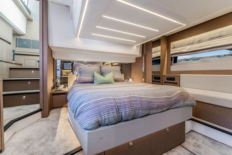 Slide: The Image of Luxurious bedroom interior of 2018 Prestige 520 yacht with modern design and cozy bedding. - 37
