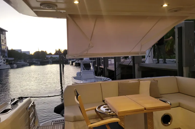 Slide: The Image of 2018 Prestige 520 yacht cruising in a scenic urban waterway. - 4