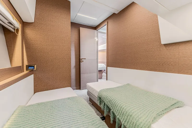 Slide: The Image of Interior of 2018 Prestige 520 yacht cabin with twin beds and modern decor. - 48