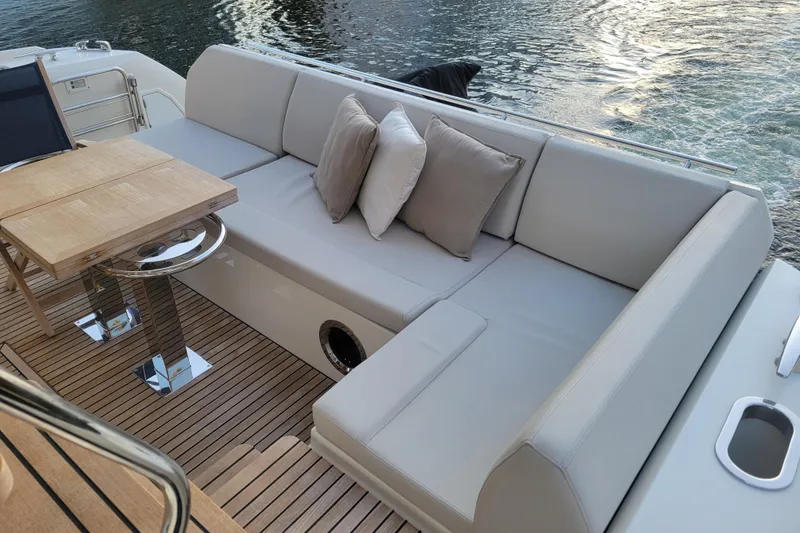Slide: The Image of 2018 Prestige 520 yacht cruising in a scenic urban waterway. - 5