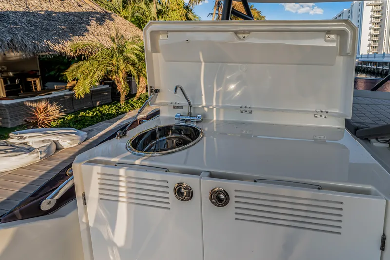 Slide: The Image of Outdoor kitchenette on 2018 Prestige 520 yacht with sink and storage. - 57