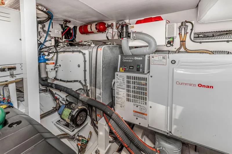 Slide: The Image of Engine room of 2018 Prestige 520 yacht with Cummins Onan generator. - 63